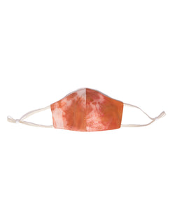 reversible silk face mask in tie dye orange and cream color with cream elastic bands