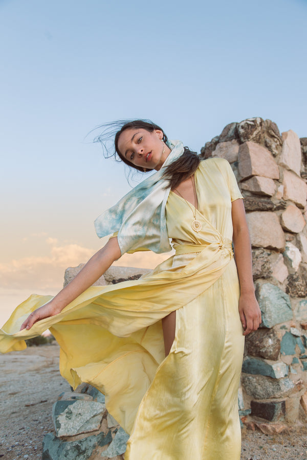 model wears medium silk scarf in light blue as hair accessory