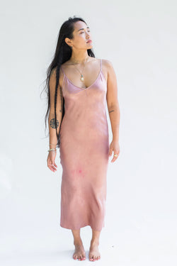 model wearing silk midi dress in muted pink