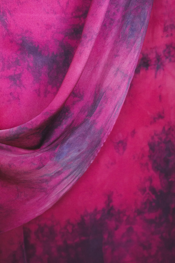 draped fabric of large silk scarf in magenta with purple tie dye markings