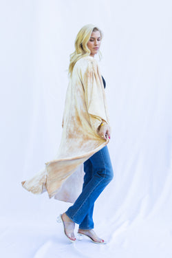 side view of women wearing velvet duster in marbled light color with peachy tones