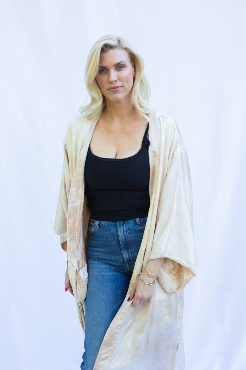 up close of women wearing reverse silk side of velvet duster in marble stone