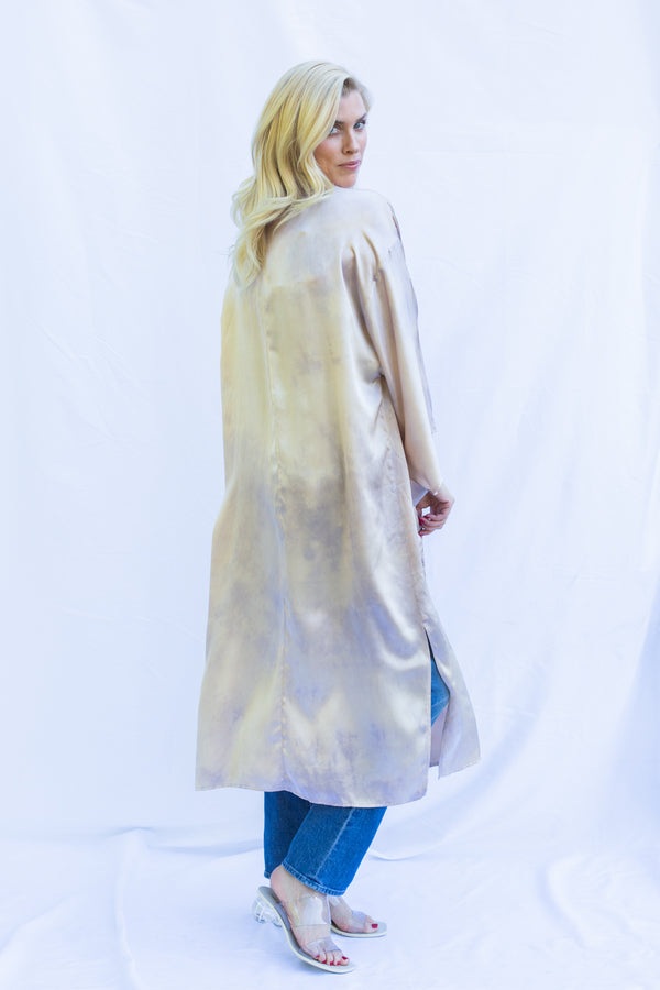 Side view of blonde woman wearing silk duster in pearly pink.