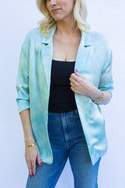 Detailed front blue of silk blazer in turquoise blue. 