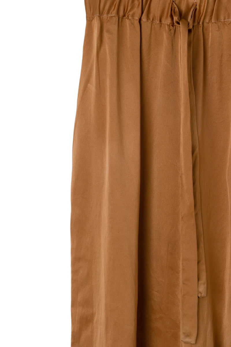 drawstring detail of silk wide leg pants in muted copper color