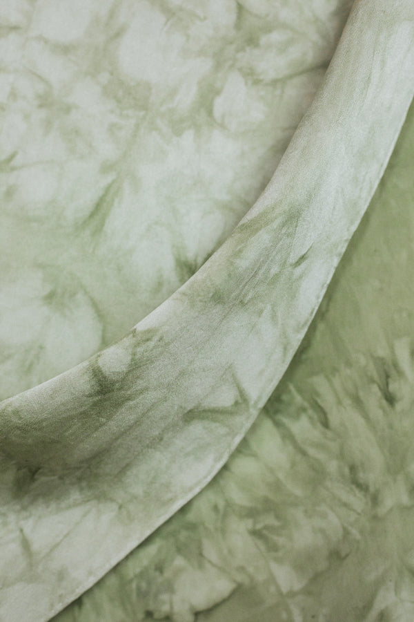 draped detail of medium silk scarf with sage green marbling